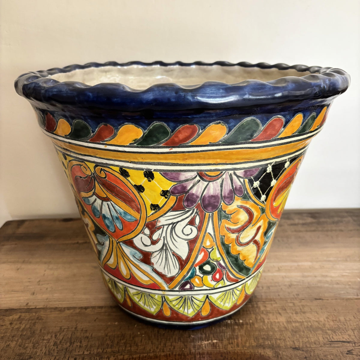 Handmade Decorative Talavera Pot from Mexico on a wooden surface.