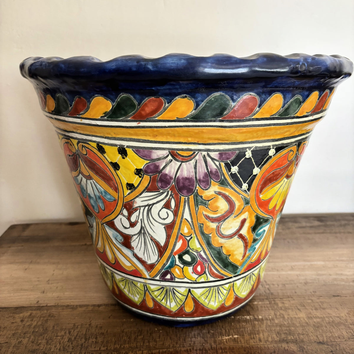 Handmade Decorative Talavera Pot from Mexico on a wooden surface.