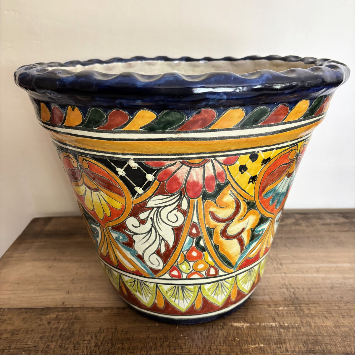Handmade Decorative Talavera Pot from Mexico on a wooden surface.