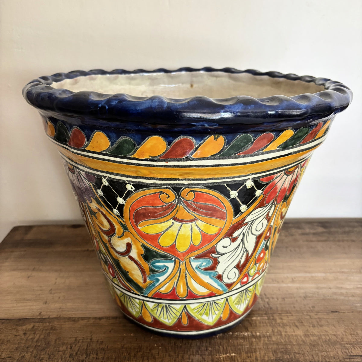 Handmade Decorative Talavera Pot from Mexico on a wooden surface.